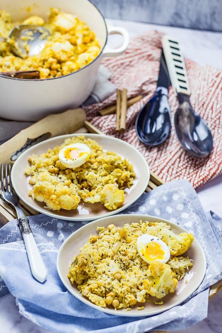 Plates of Biryani with Cauliflower & Chickpeas on a blue spotted cloth and wooden tray