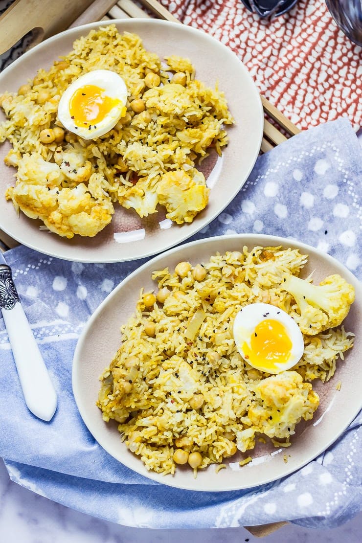 Biryani with Cauliflower & Chickpeas on a plate with a spotted cloth on a wooden tray