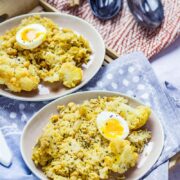 Biryani with Cauliflower & Chickpeas on a wooden tray and blue cloth