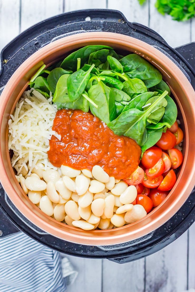 Ingredients for One Pot Cheesy Pearl Barley with Tomatoes in a pressure cooker