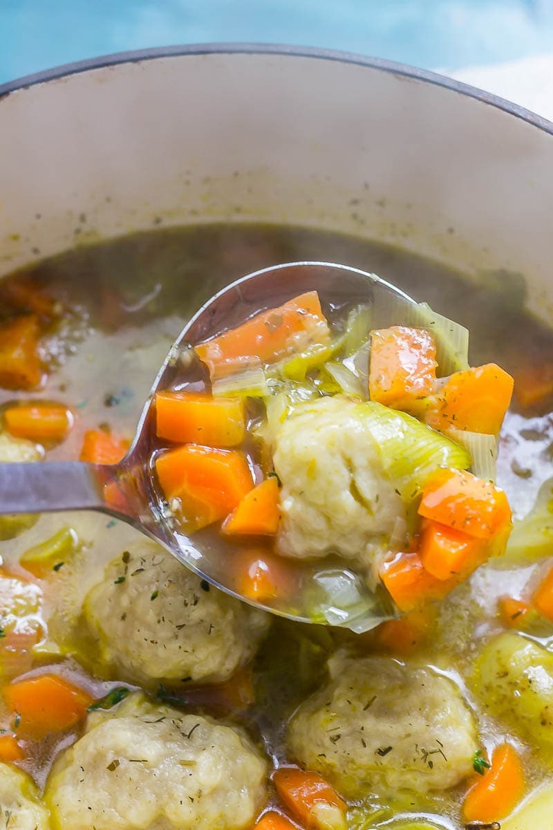 Ladleful of vegetable soup with dumplings 