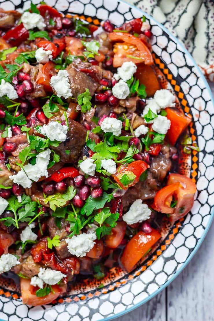 Close up of Smoky Aubergine Salad with Red Pepper topped with feta