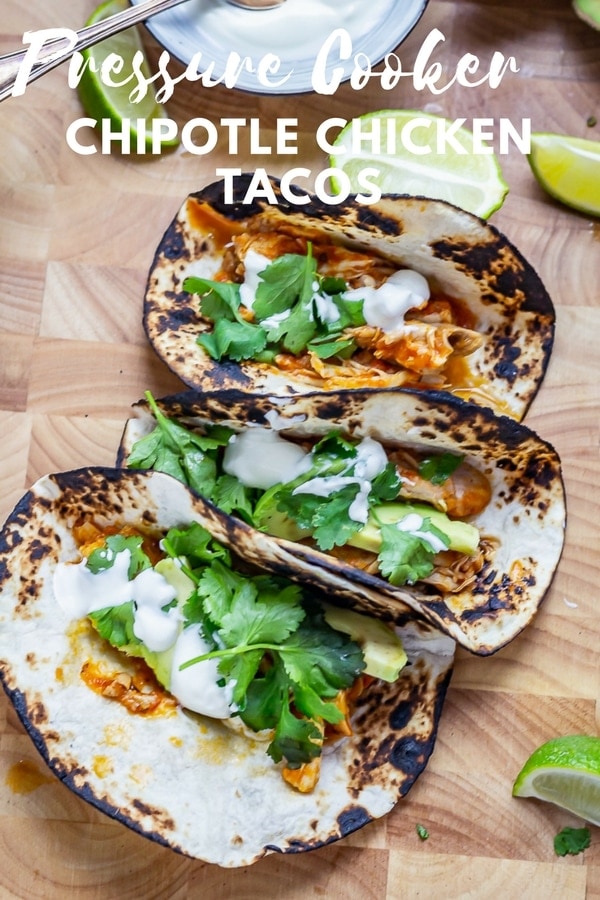 These chipotle chicken tacos are made so quick and easy by using a pressure cooker or instant pot. The chicken is cooked in a spicy tomato sauce then shredded before stuffing into the tacos with all your favourite toppings. #chickentacos #tacos #instantpot #pressurecooker #thecookreport