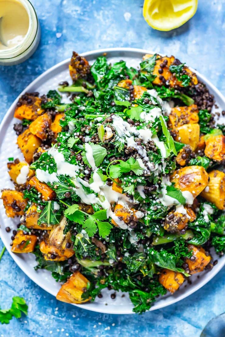 Overhead shot of Sweet Potato and Quinoa Salad with Sesame Dressing on a blue background 