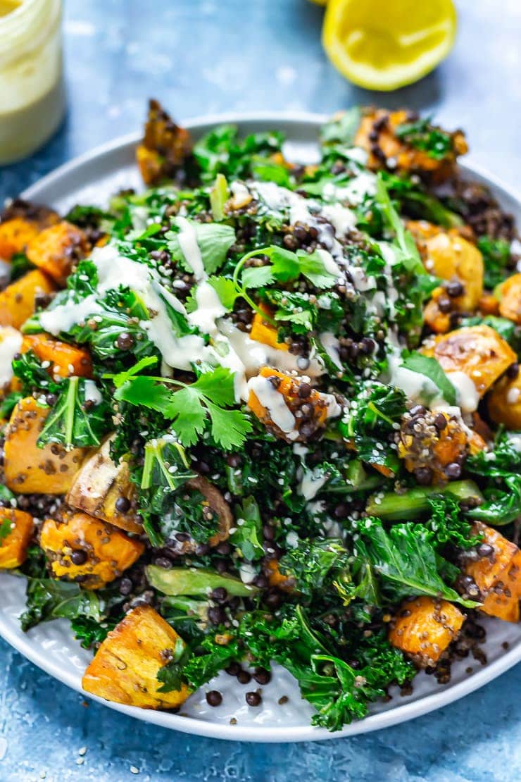 Sweet Potato and Quinoa Salad with Sesame Dressing on a blue background with lemon in the background