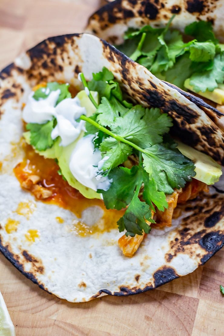 Close up of a chipotle chicken taco on a wooden board