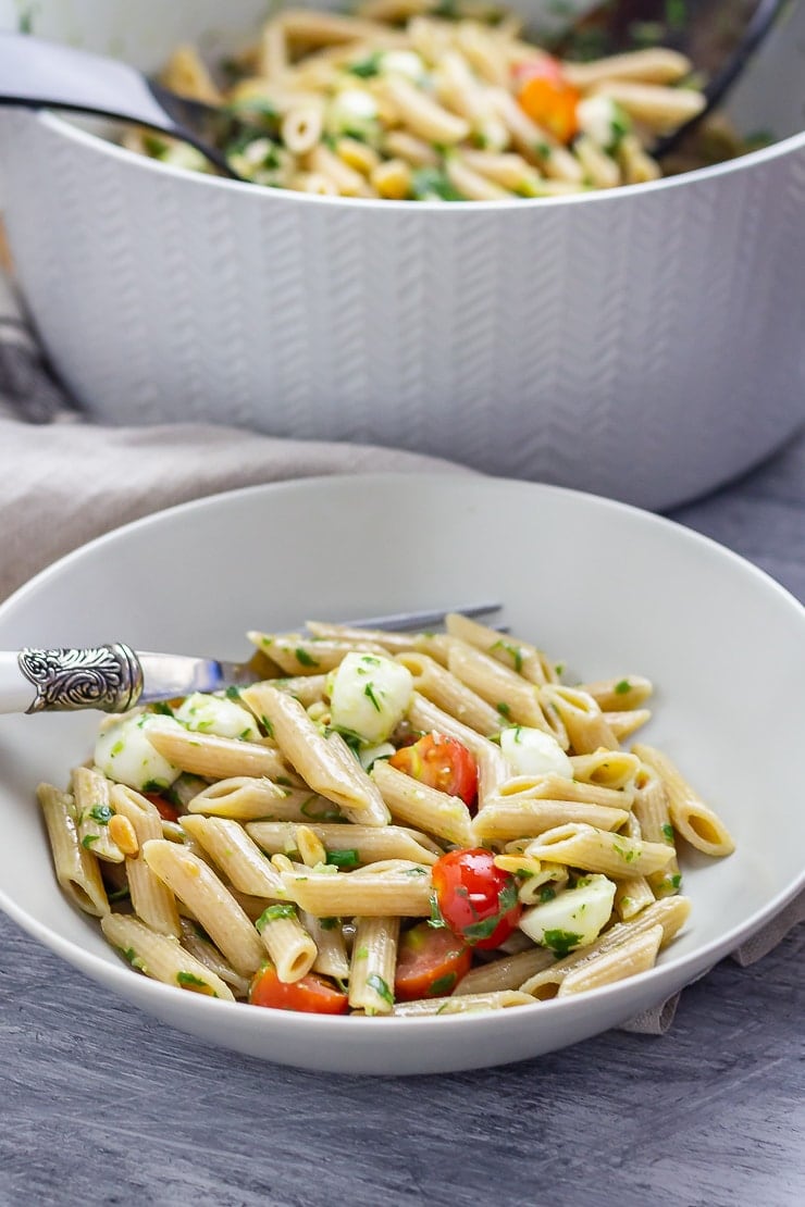 Bowl of caprese pasta salad with fork