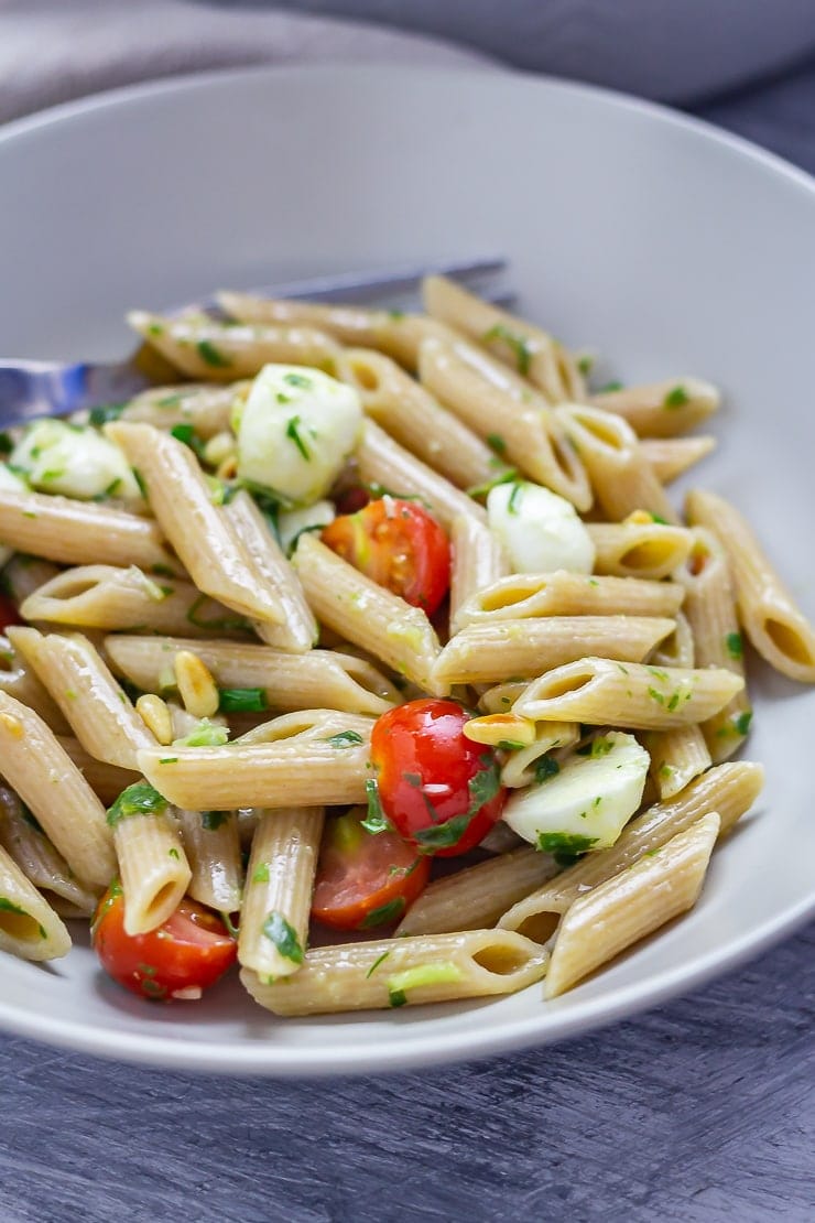 Bowlful of caprese pasta salad with a fork