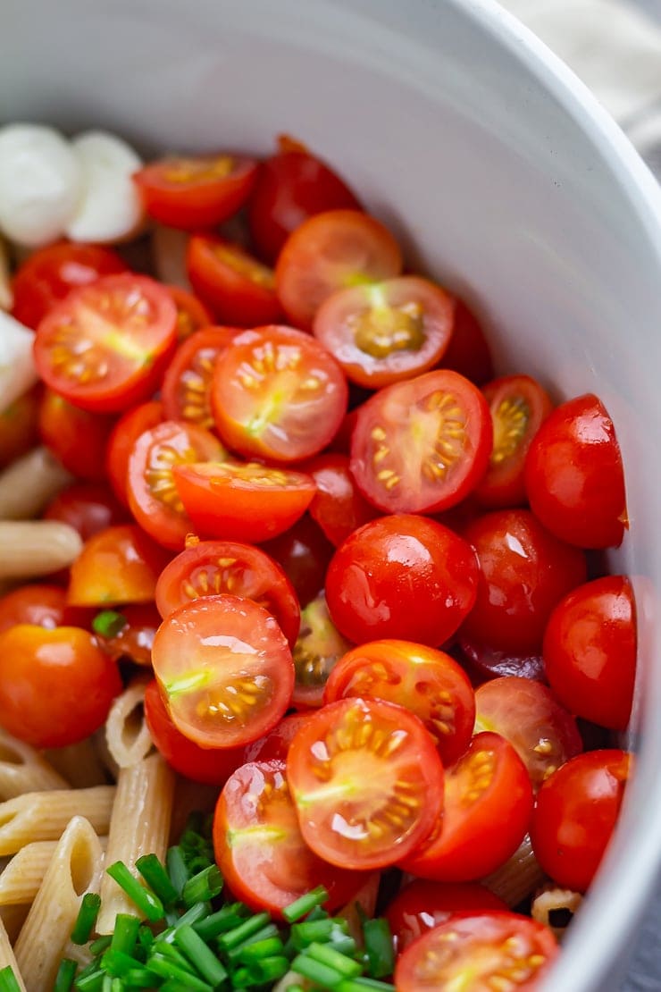 Close up of tomatoes in caprese pasta salad