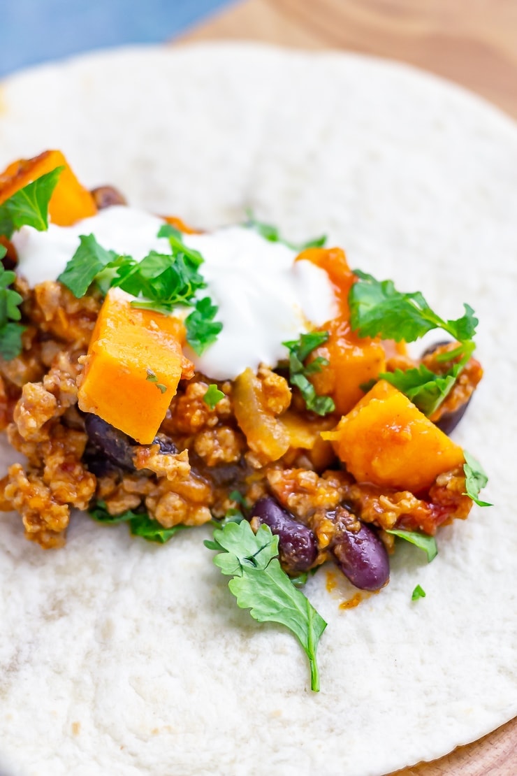 Turkey chilli on a wrap on a wooden board