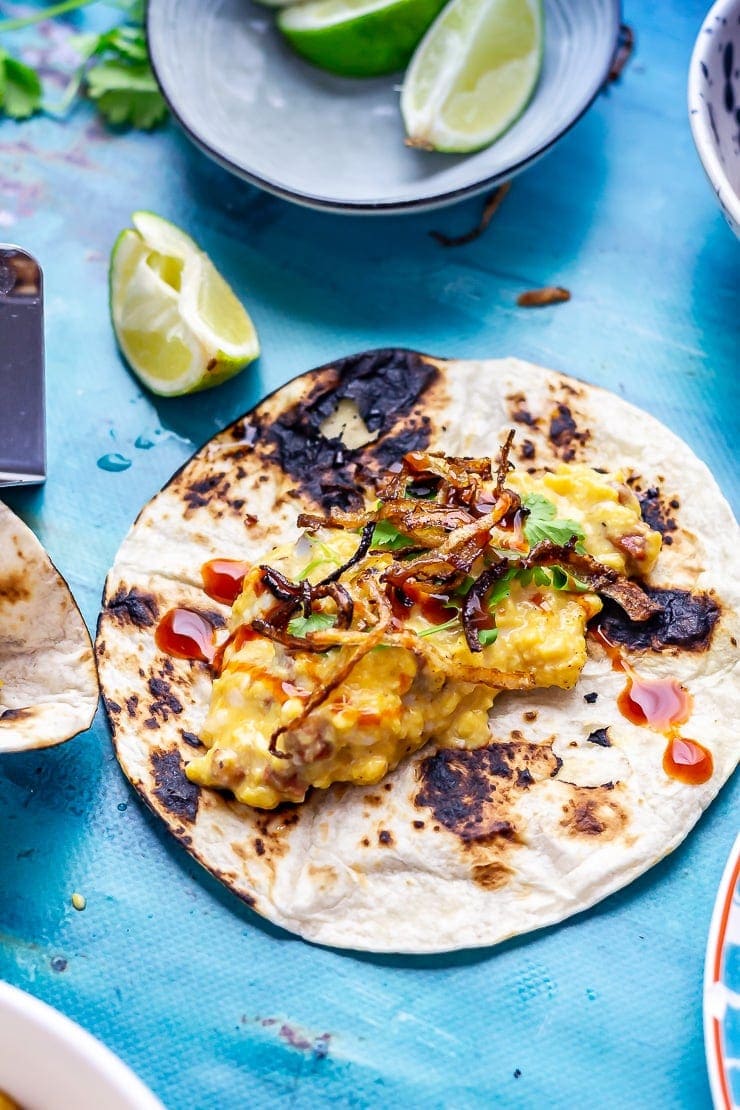 Breakfast tacos on a blue background with lime