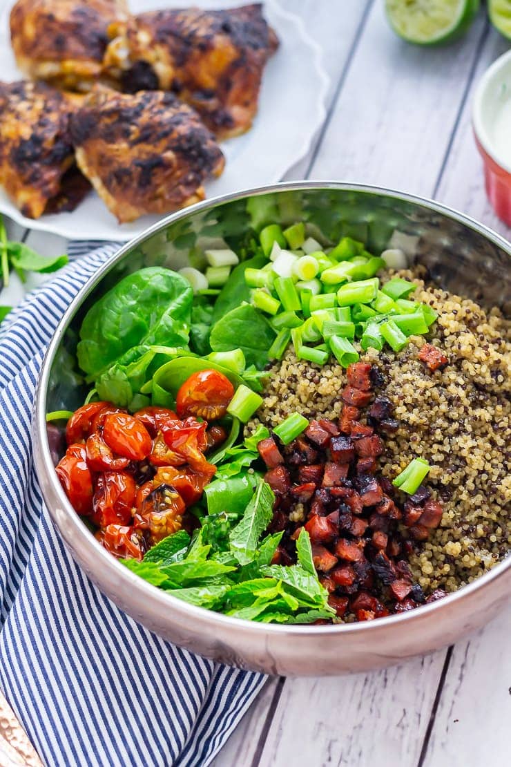 Ingredients for chicken salad in a bowl on a white wooden background with chicken and dressing