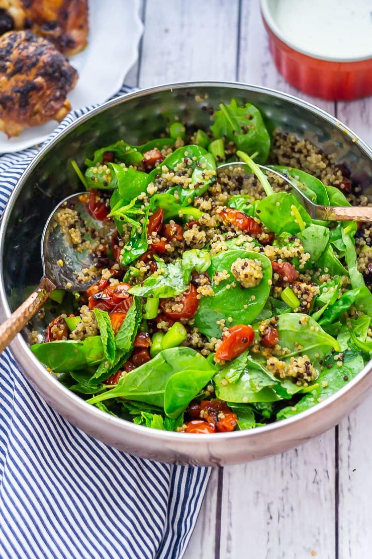 Chipotle chicken salad on a white wooden background with a striped cloth