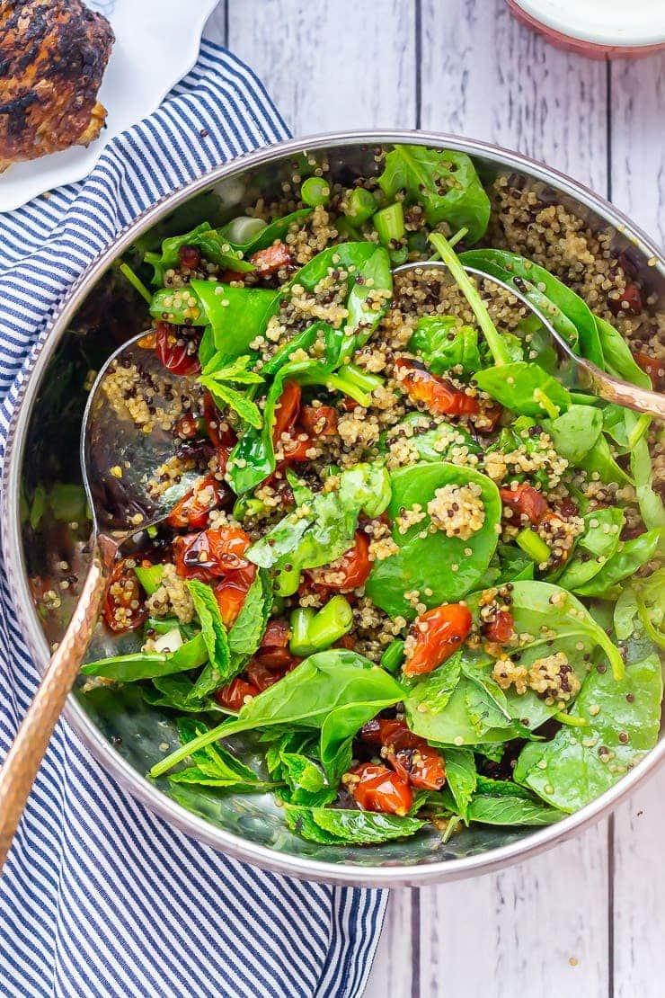 Overhead shot of chipotle chicken salad on a white wooden background with a striped cloth