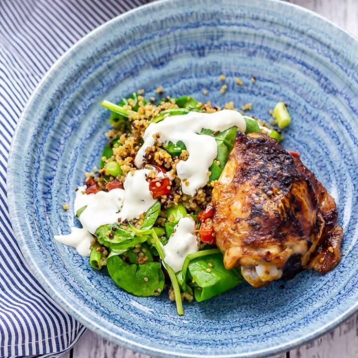 Chipotle chicken salad with quinoa in a blue bowl on a white wooden background