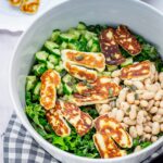 Halloumi salad in a bowl on a checked cloth on a marble background