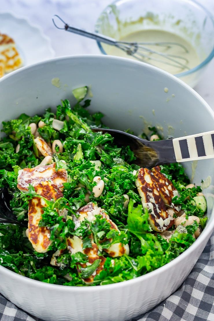 Halloumi salad with kale with salad servers