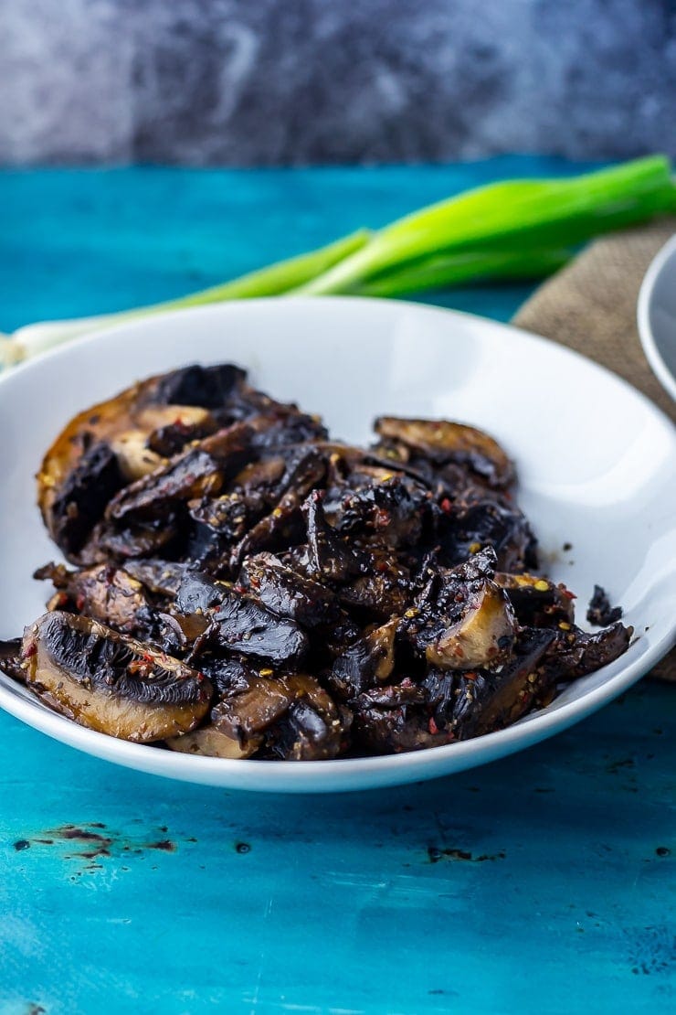 Bowl of mushrooms for mushroom bao on a blue background