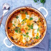 Overhead shot of one pot vegetarian lasagne on a blue background