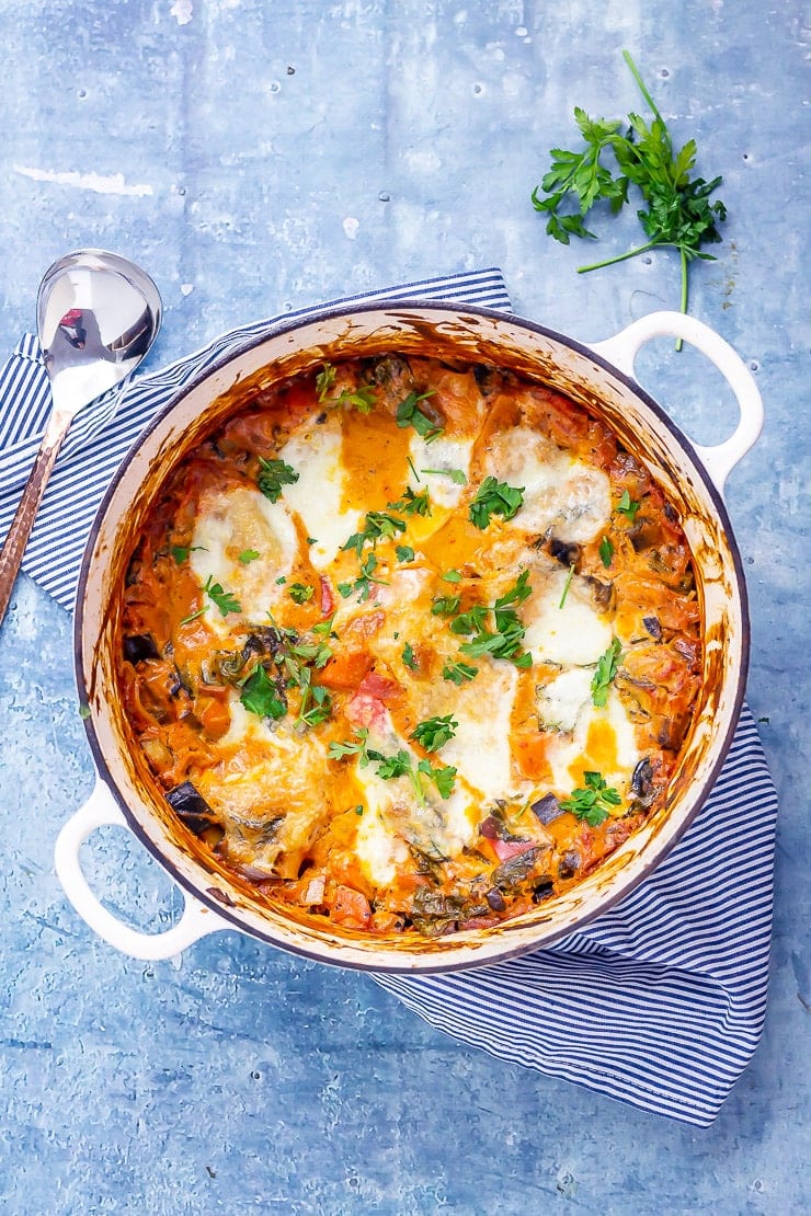 Overhead shot of one pot vegetarian lasagne on a blue background