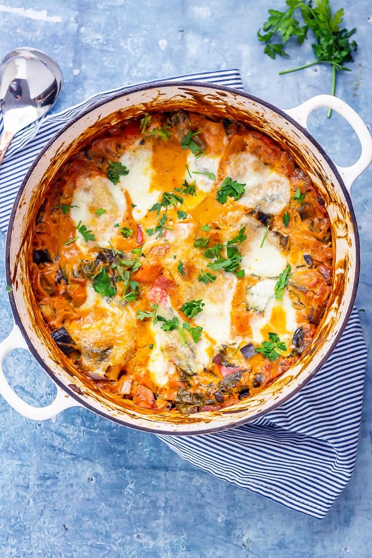 Overhead shot of one pot vegetarian lasagne on a blue background