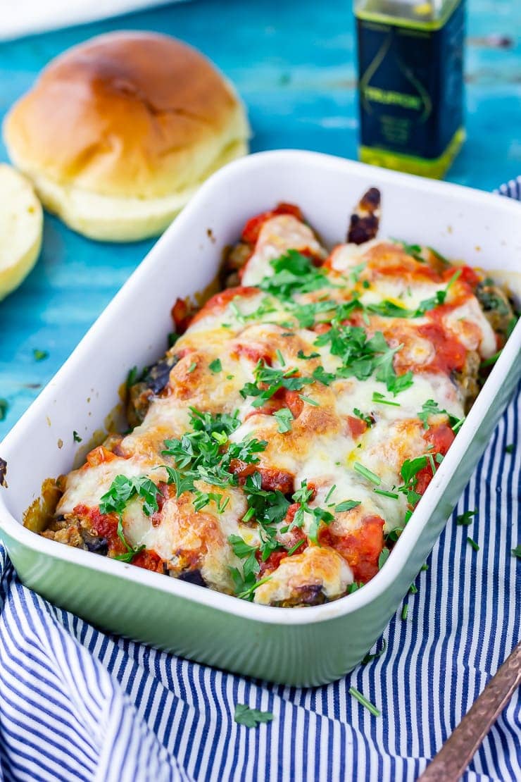 Vegetarian meatball bake in a green dish on a striped cloth