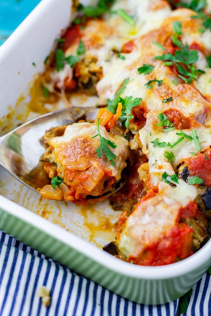 Vegetarian meatball bake in a green dish on a striped cloth