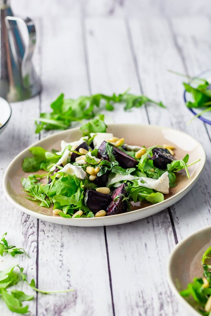 Side on shot of beetroot salad on a white wooden background