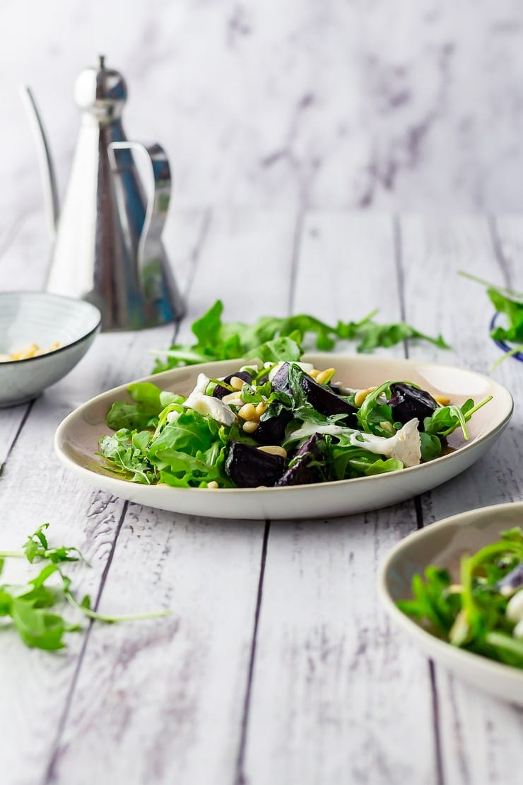 Side shot of beetroot salad on a white wooden background