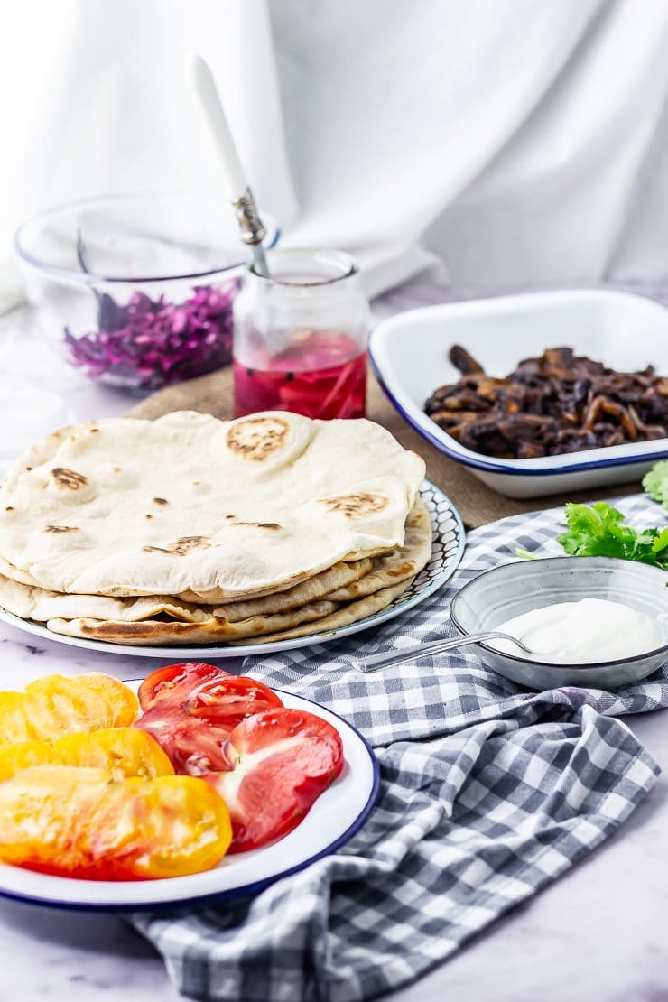 Photo of ingredients for mushrooms wraps on a checked cloth