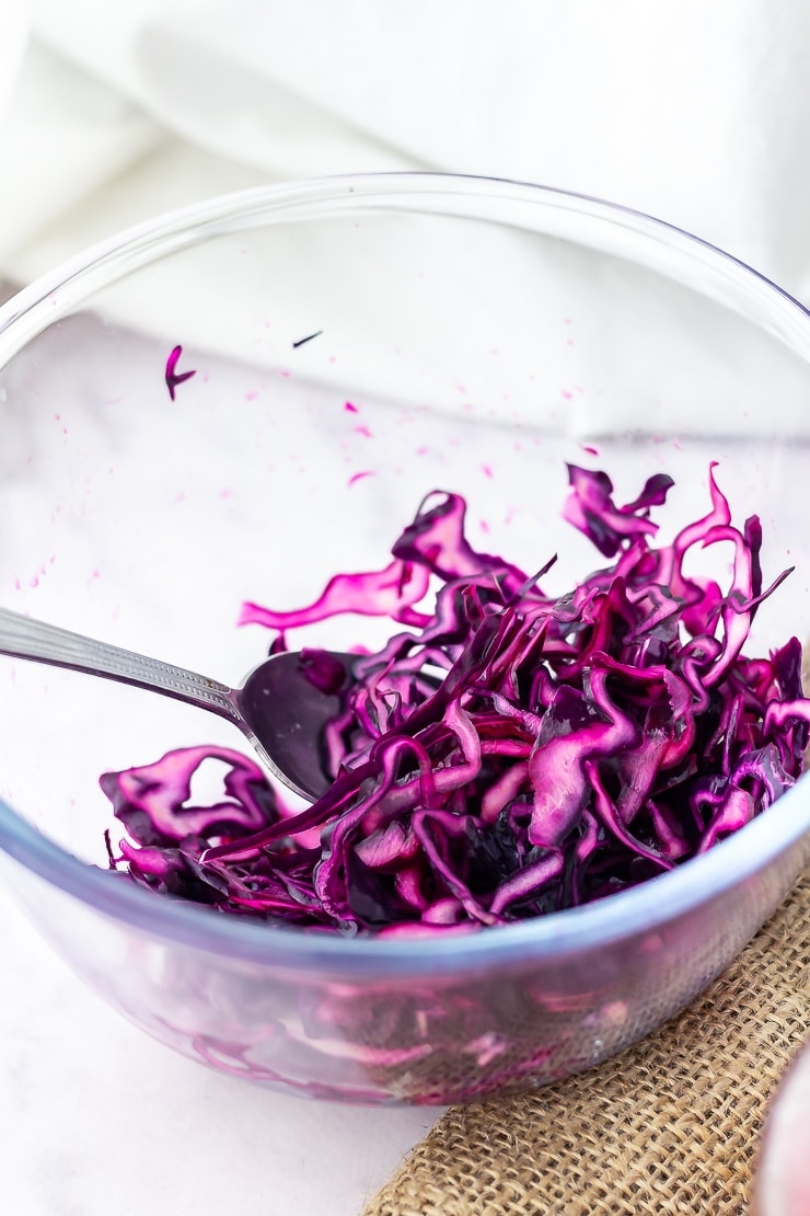 Red cabbage in a glass bowl on a marble background