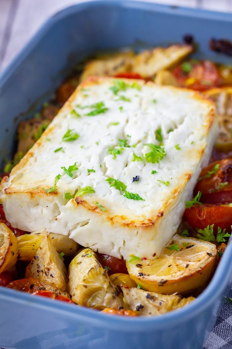 Baked feta with vegetables in a blue baking dish