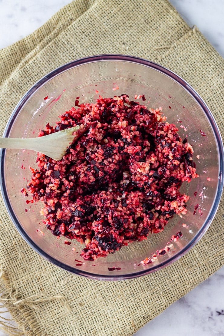 Overhead shot of the mixture for beetroot burgers in a glass bowl