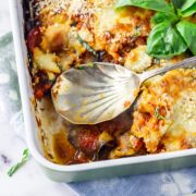 Overhead shot of aubergine parmigiana with a spoon