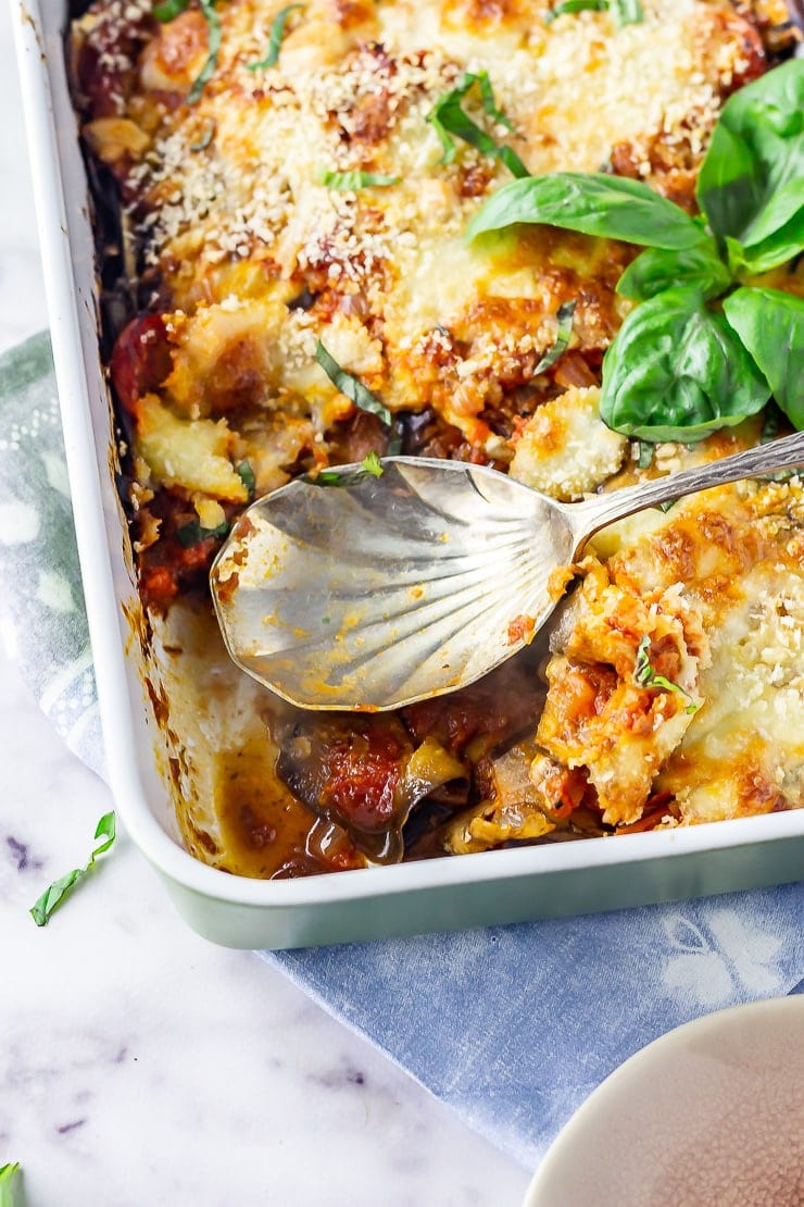 Overhead shot of aubergine parmigiana with a spoon