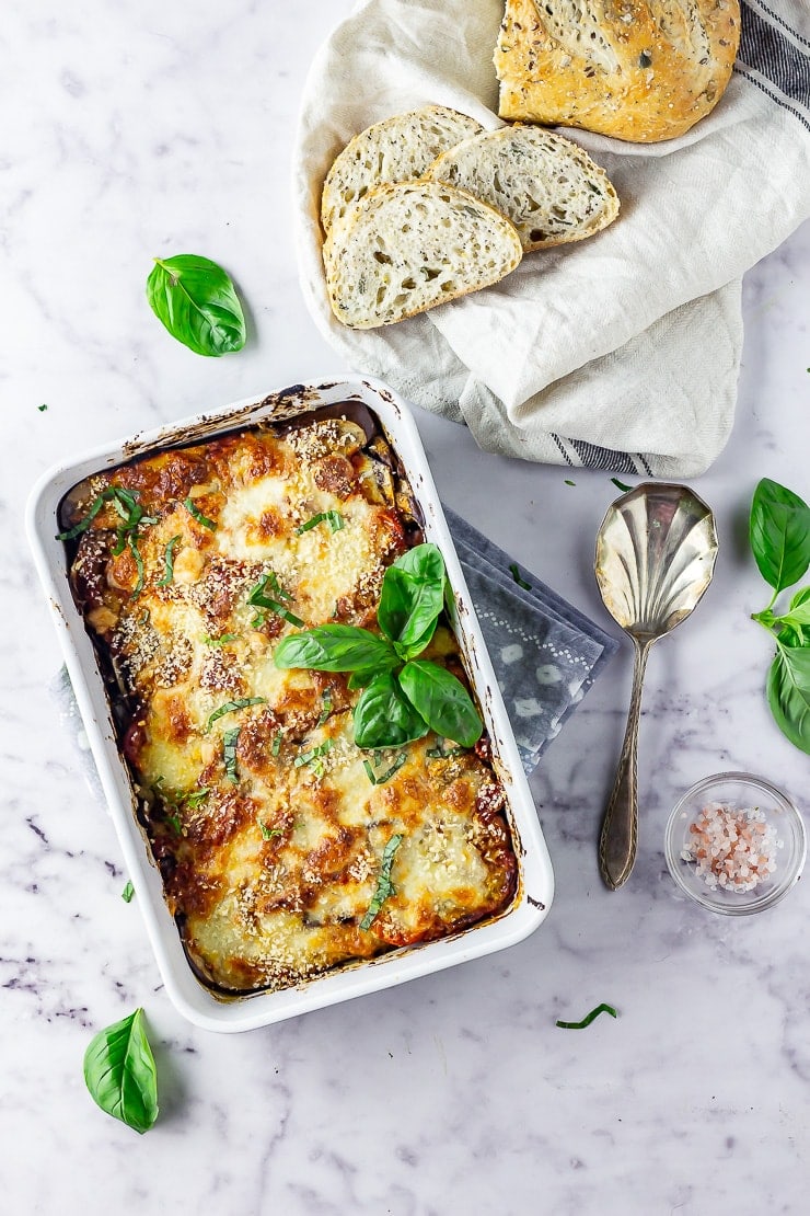 Overhead shot of aubergine parmigiana on a marble background