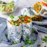 Vegetarian breakfast burrito on a striped cloth