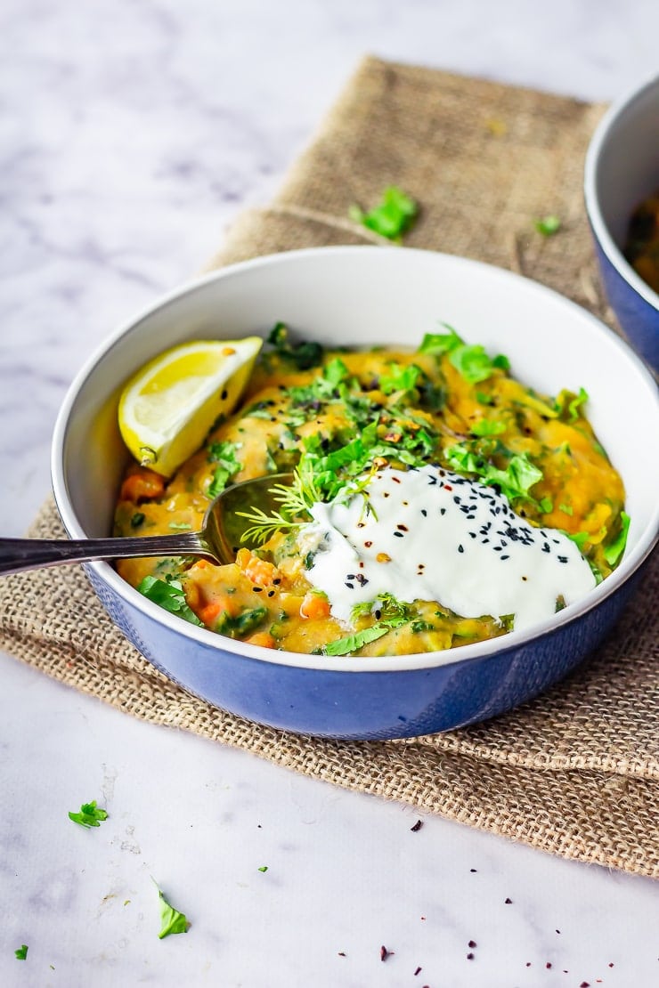 20 Minute Dinners: Bowl of pressure cooker lentil stew on a mat over a marble background