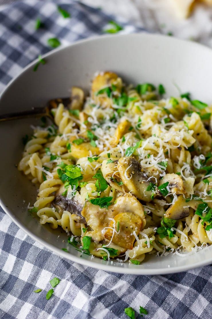 Bowl of mushroom pasta on a checked cloth