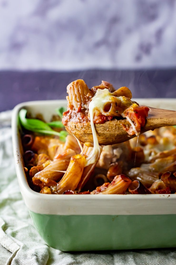 One pot cheese and tomato pasta bake with a spoonful being taken