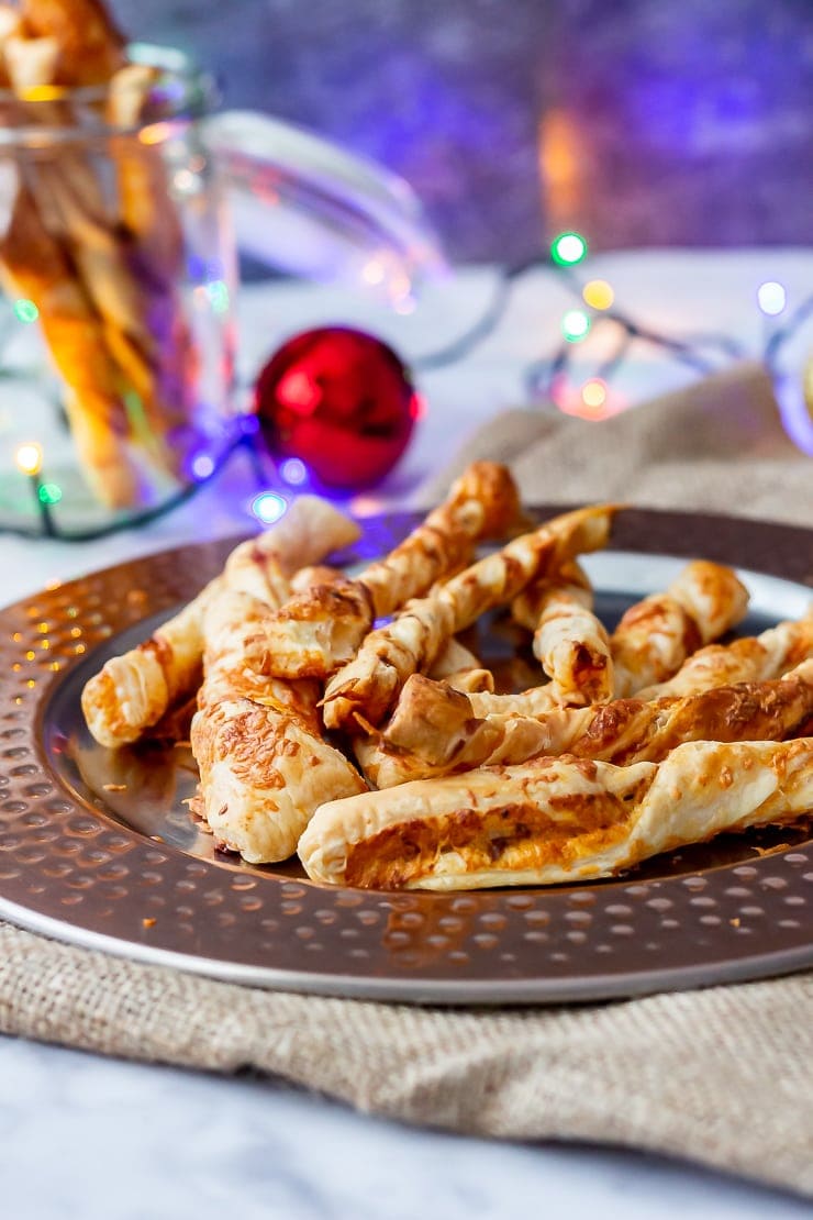 Side angle shot of chipotle cheese twists on a bronze platter