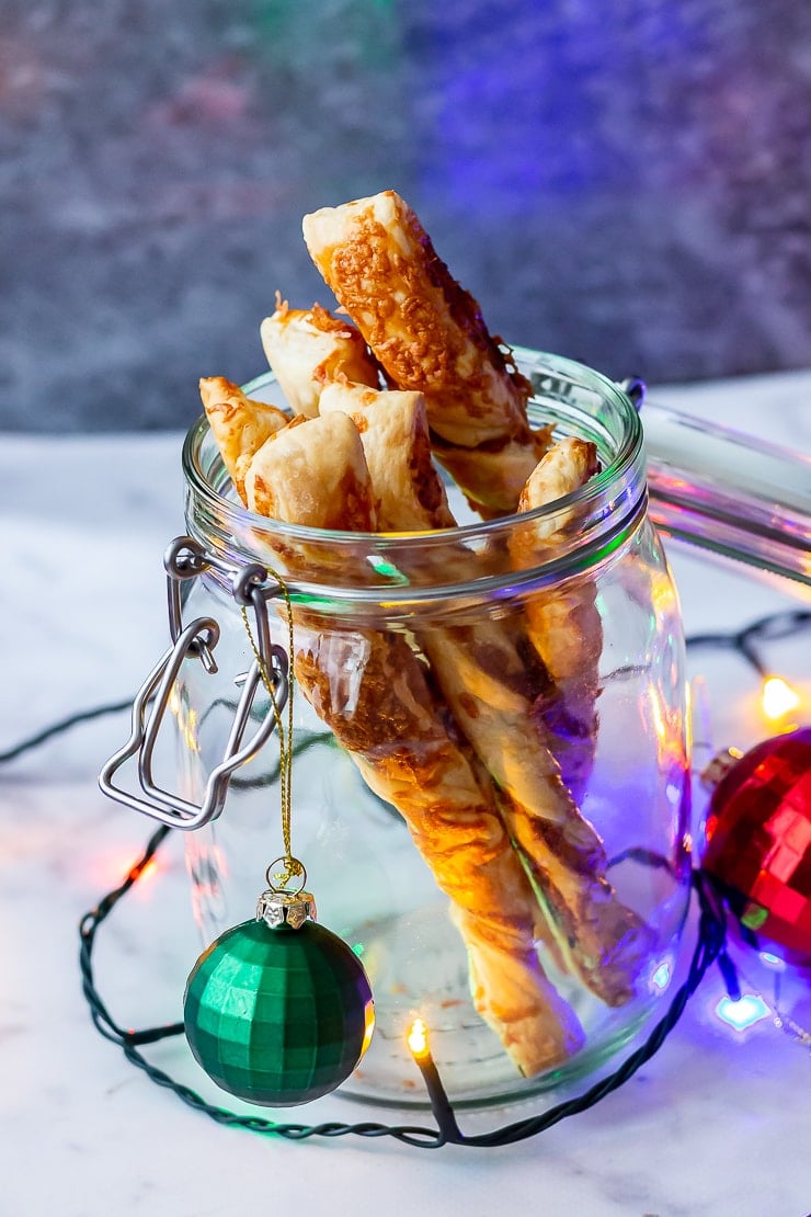 Side on shot of chipotle cheese twists in a glass jar