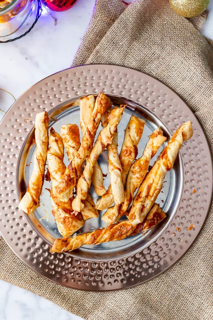 Overhead shot of chipotle cheese twists on a bronze platter