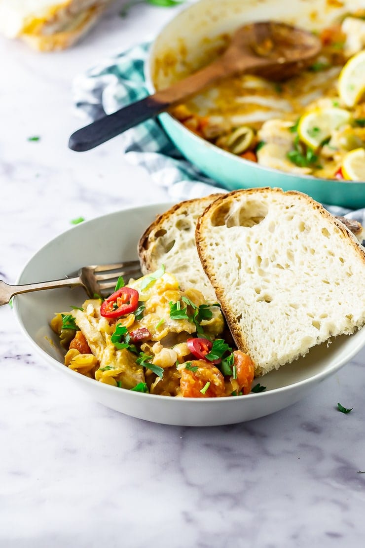 Bowl of fish stew with crusty bread