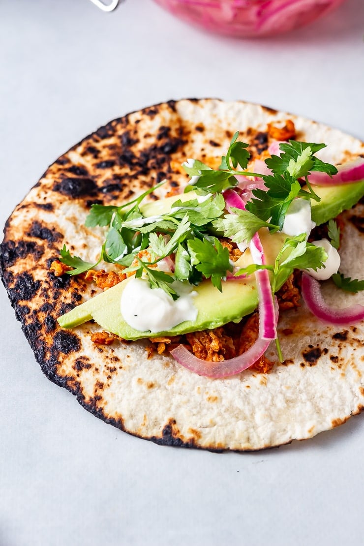 20 Minute Dinners: Close up of salmon tacos on a grey background