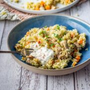 Leftover turkey pilaf in a blue bowl on a white wooden background