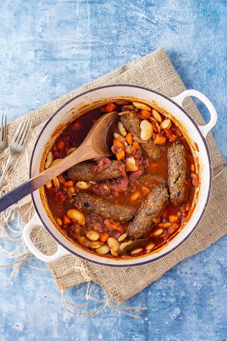 Overhead shot of vegetarian sausage casserole on a blue background