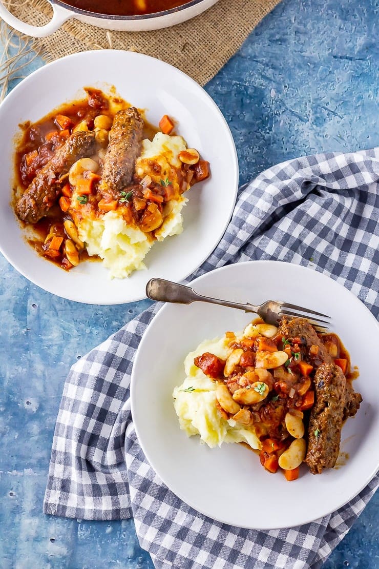 Overhead shot of two bowls of vegetarian sausage casserole with mash