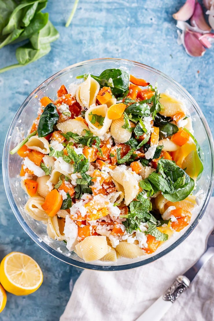 Overhead shot of butternut squash pasta on a blue background