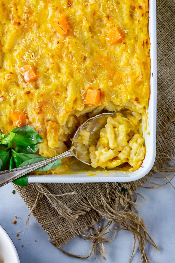 Overhead shot of sweet potato mac and cheese with a spoonful taken